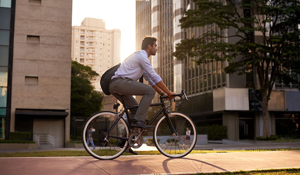 Join the Energy Efficiency Movement Newsletter - Man biking in a city.